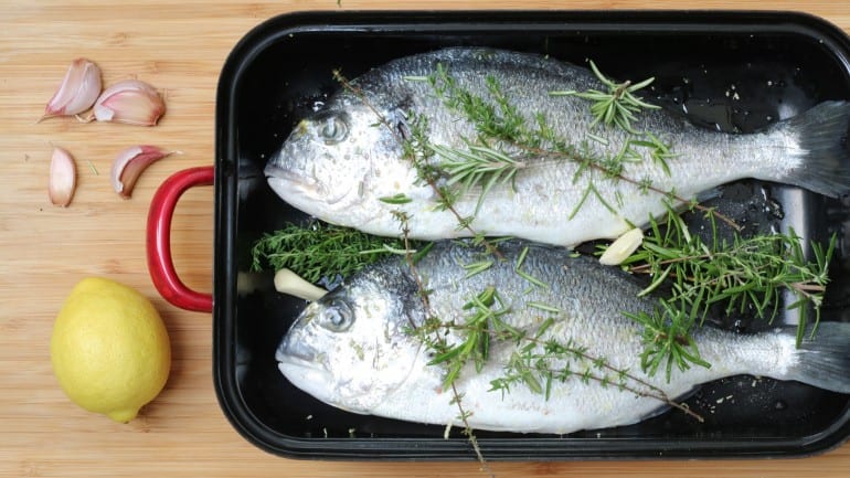 Prepare the sea bream for grilling with herbs and garlic