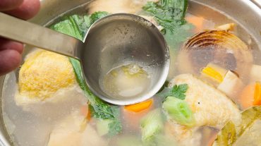 preparing chicken soup in a pot