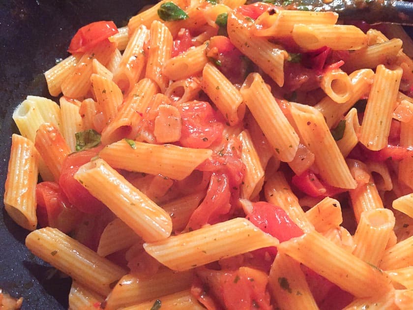near photo of penne with tomato sauce