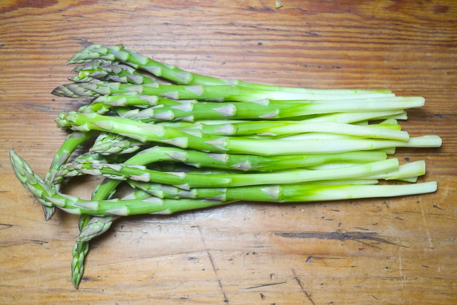 Peeled green asparagus on the kitchen table