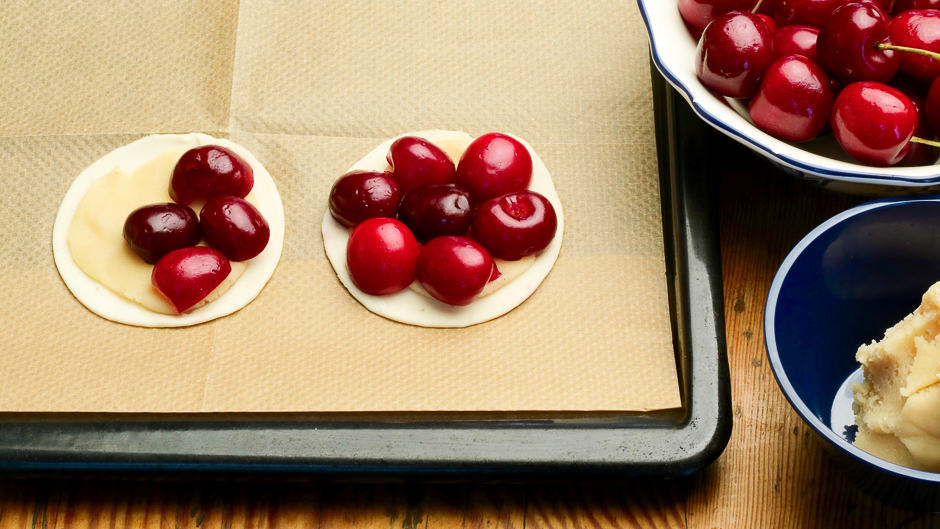 Top the cherry cake with cherries.
