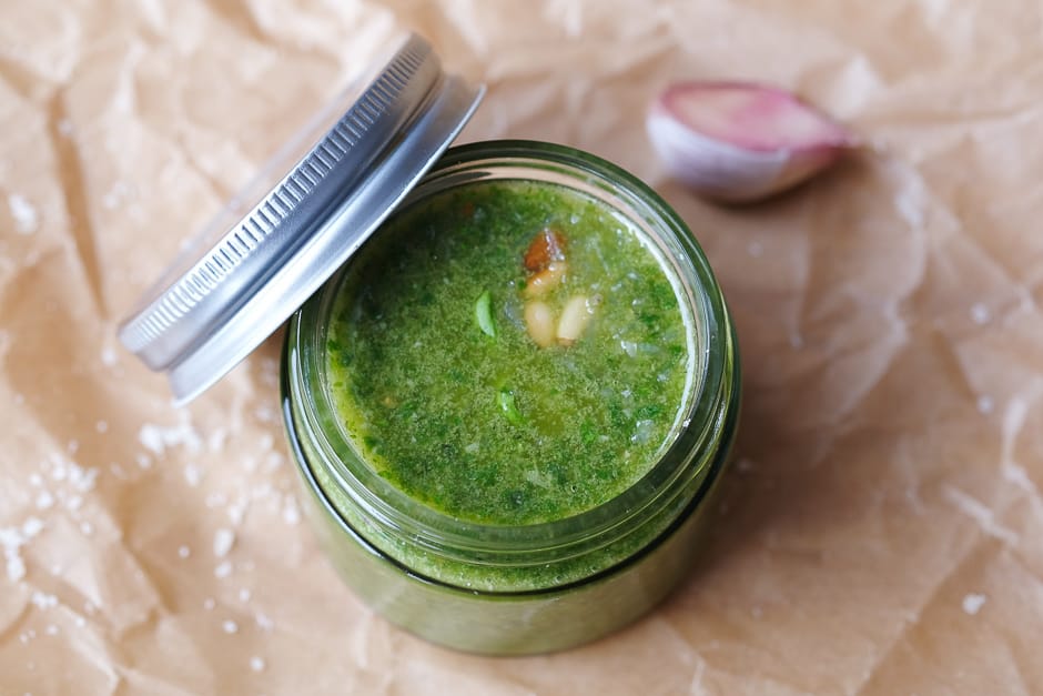 Homemade pesto in a glass photographed from above.