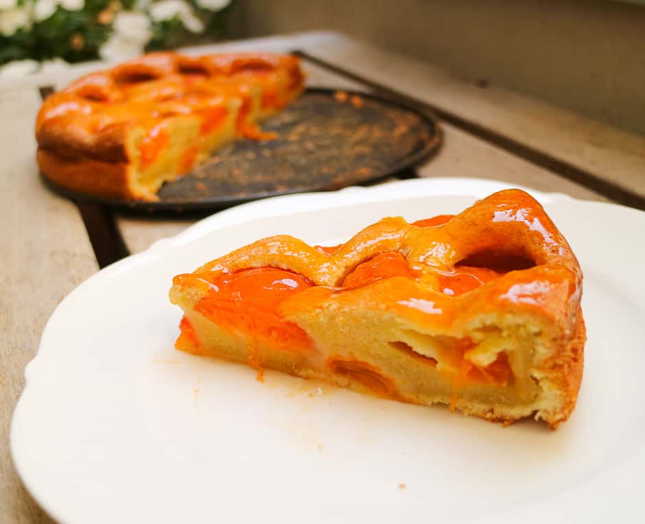 Sliced apricot cake, cake surface and fruits shine.