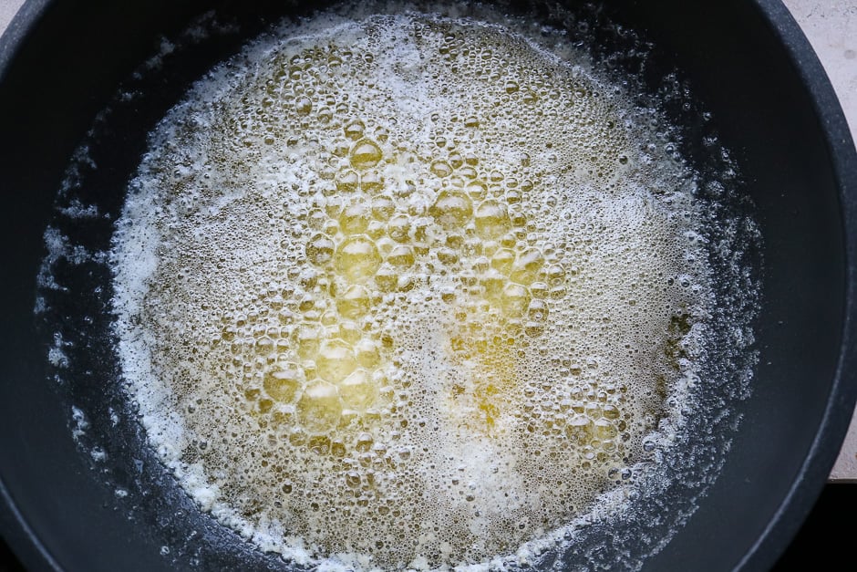 Butter in a saucepan while cooking.