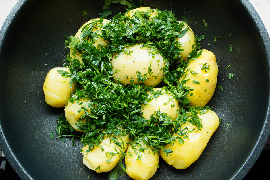 Jacket potatoes prepared in a pan.