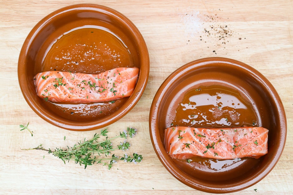 Salmon fillets in ovenproof forms when seasoning
