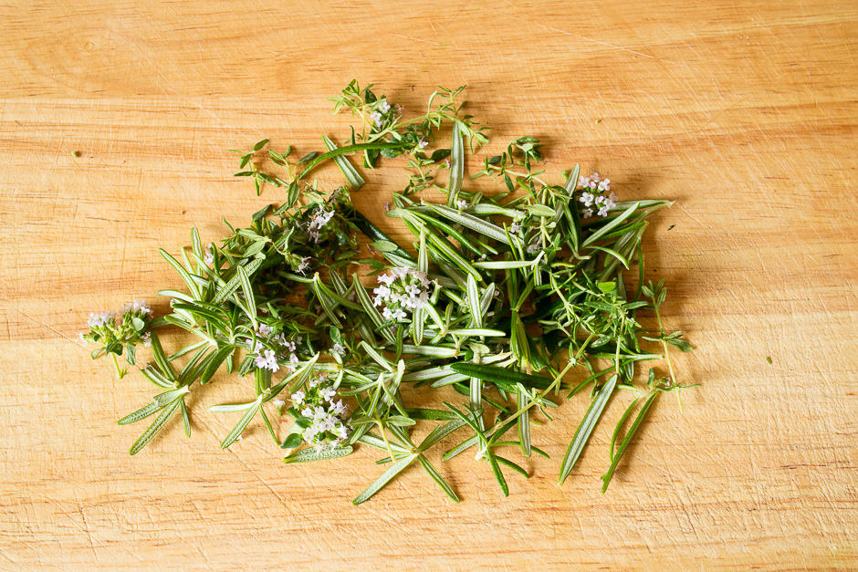 Pluck the herbs and place them on a pile.