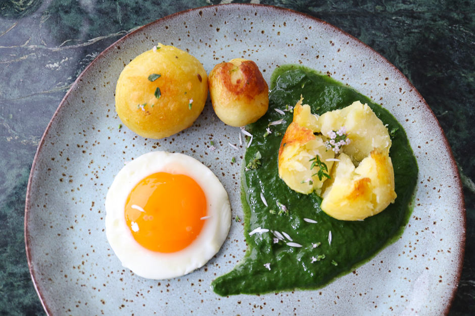 Fried egg with creamed spinach and potatoes.