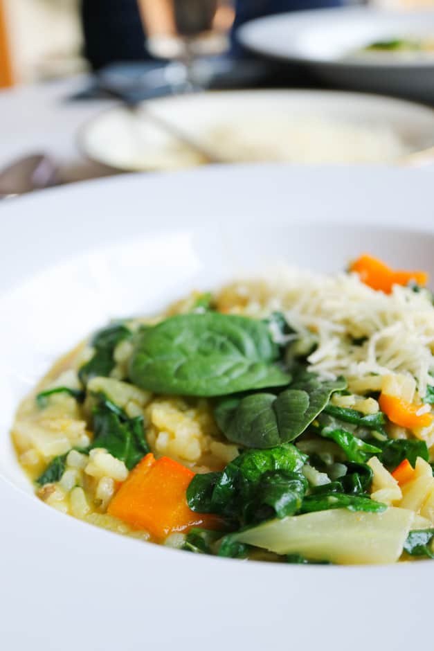 Pumpkin risotto with spinach leaves