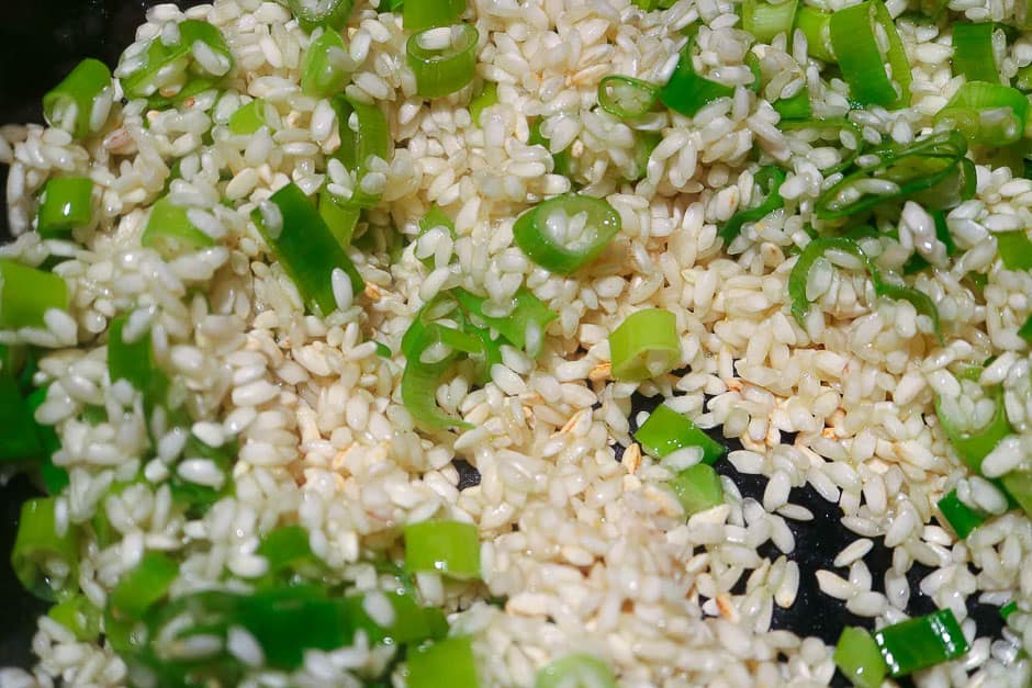 Risotto rice and onions while sautéing.