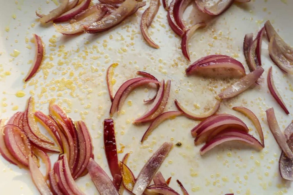 Red onion strips in the pan