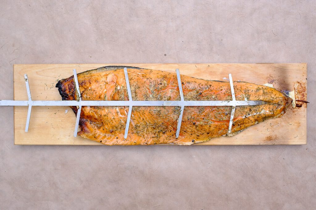 Flamed salmon cooked on a board