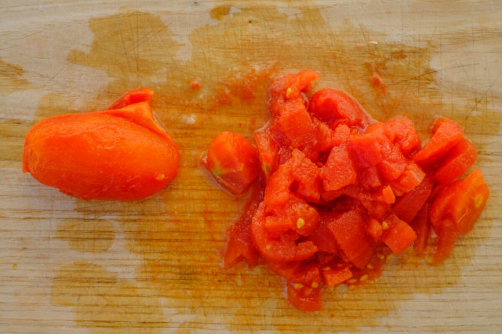 Chop the canned tomatoes until sticky