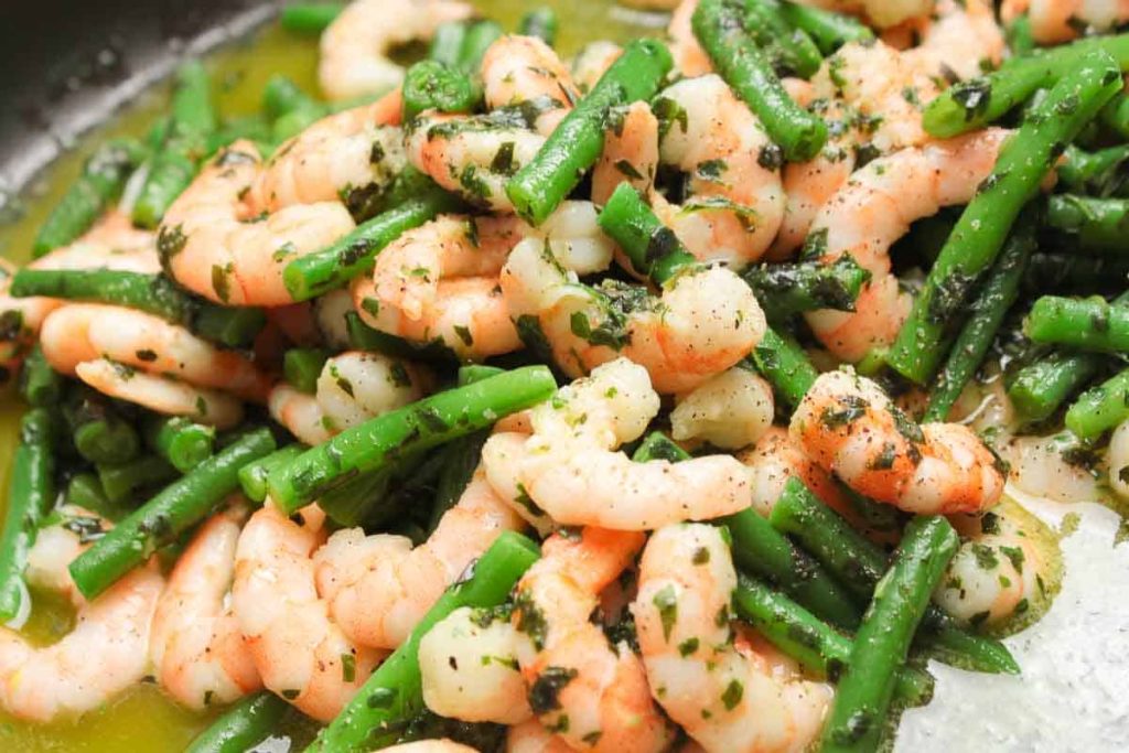 Prawns and beans in the salad marinade, tasty and shiny with flavor.