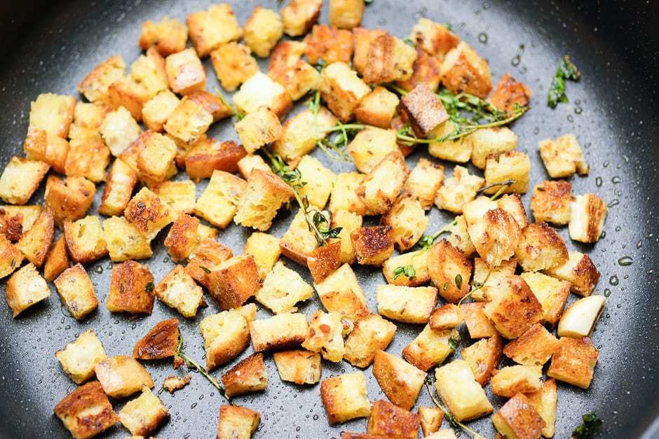 Croutons bread cubes while roasting in the pan.