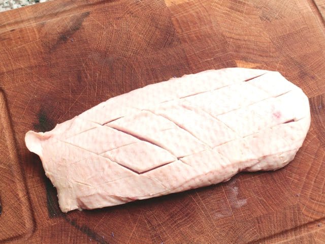 Cut the skin of the duck breast crosswise.
