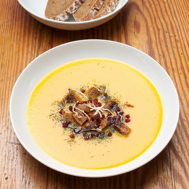 Styrian pumpkin cream soup with bacon and bread cubes