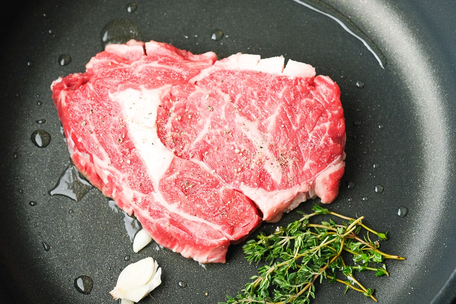 Sear the steak in the hot pan.