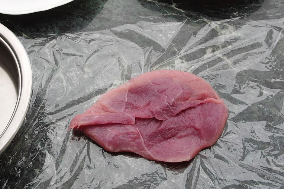 raw schnitzel for tapping on cling film