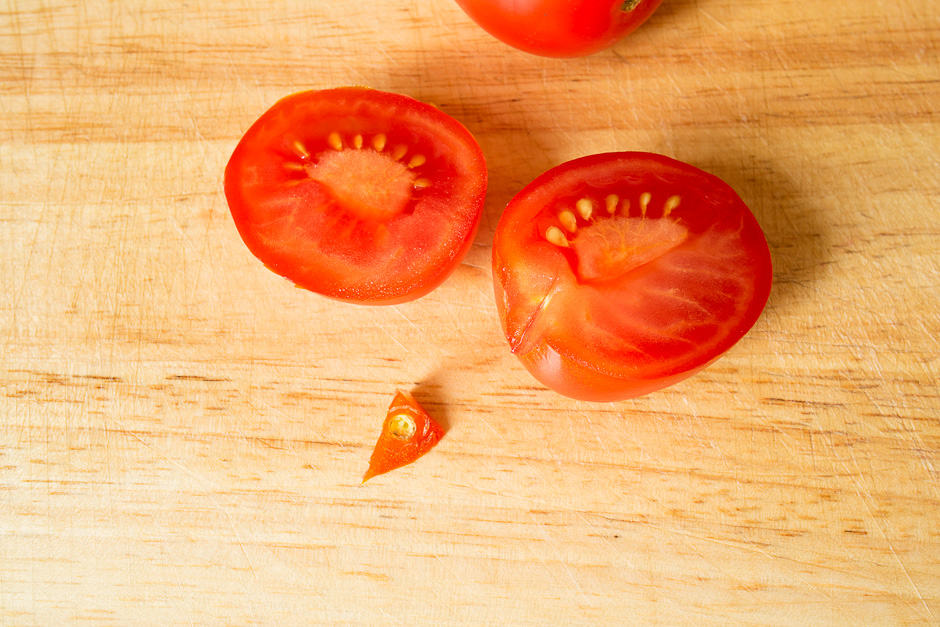 Cut tomatoes for tomato salad.