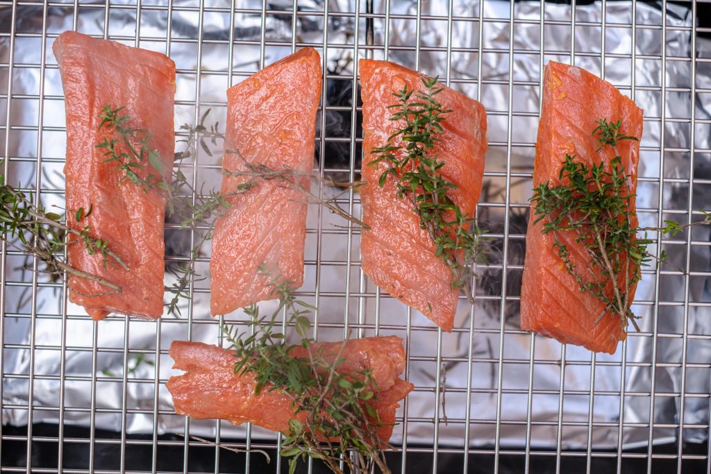 Salmon fillets smoking with thyme