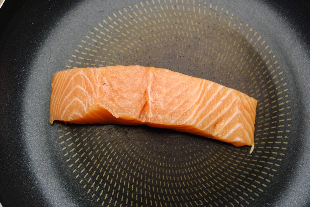 Put salmon in the hot pan