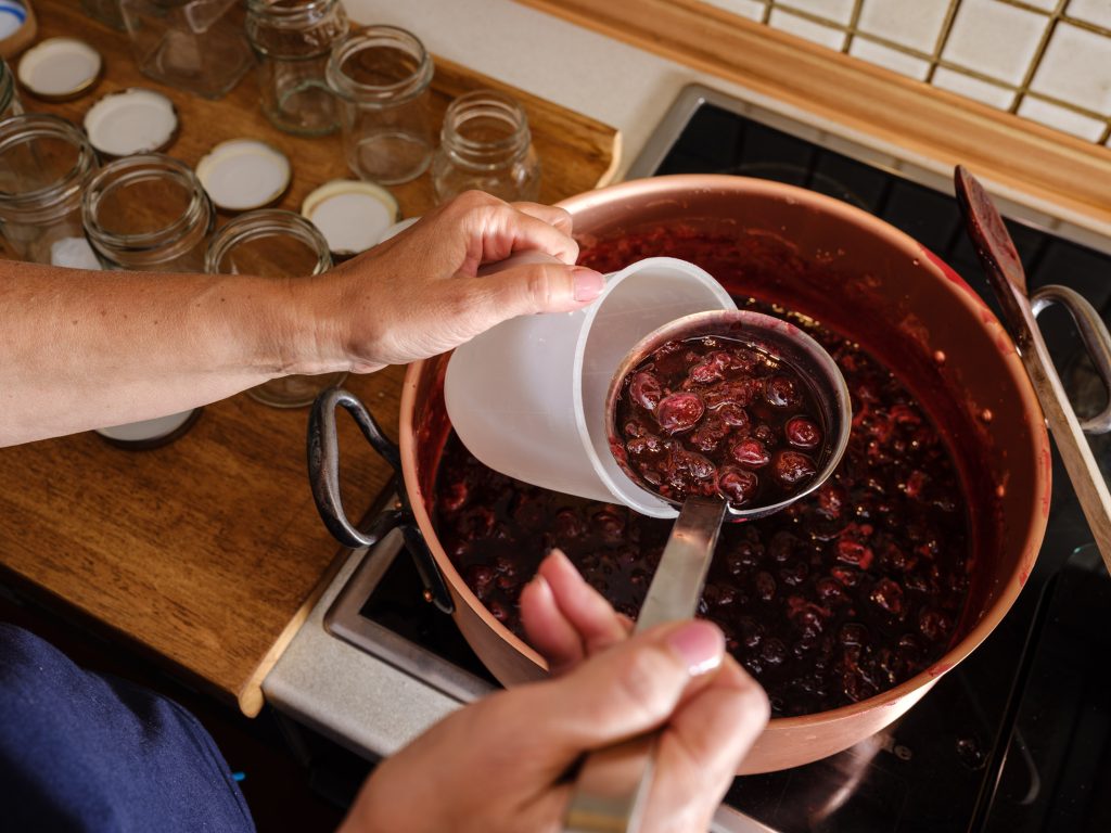 Pour cherry jam into spout cups