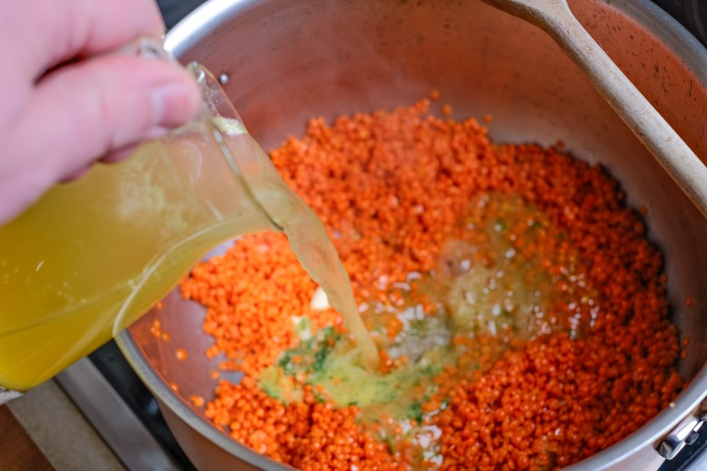 Deglaze lentils with broth