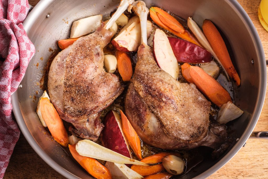 browned goose legs with vegetables