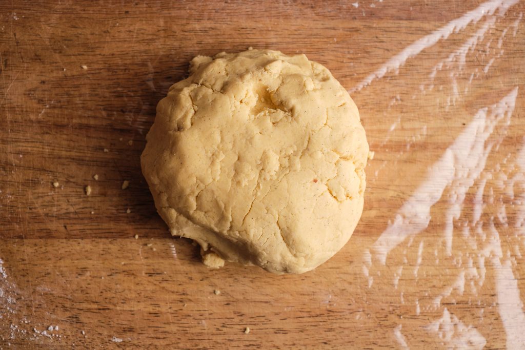 Ball-shaped vanilla croissant dough on cling film
