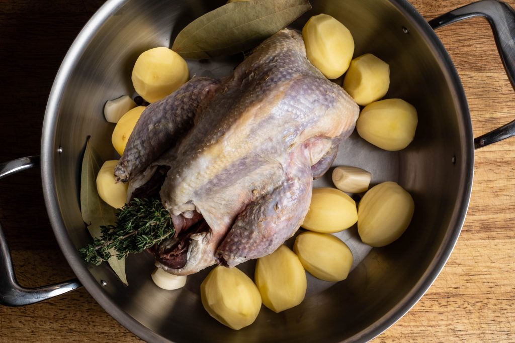 Pheasant in a roaster with potatoes