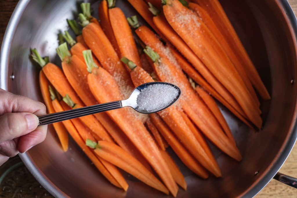 Season carrots with salt