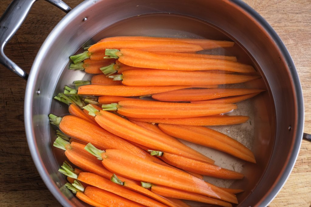 Boil carrots in the pot