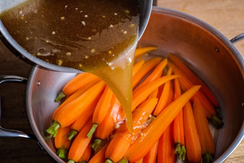 Pour the dressing over the cooked carrots