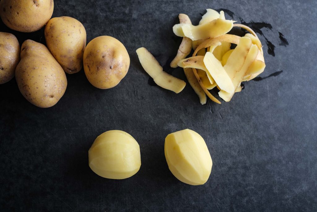 Peel raw potatoes