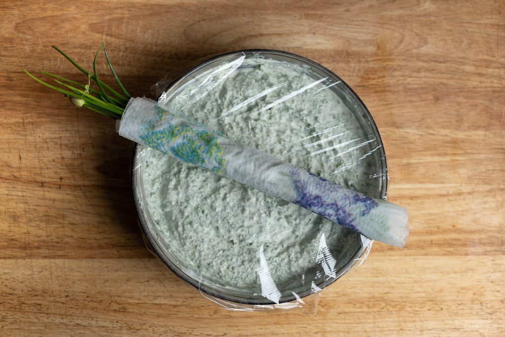The Frankfurt green sauce covered with foil with chives.