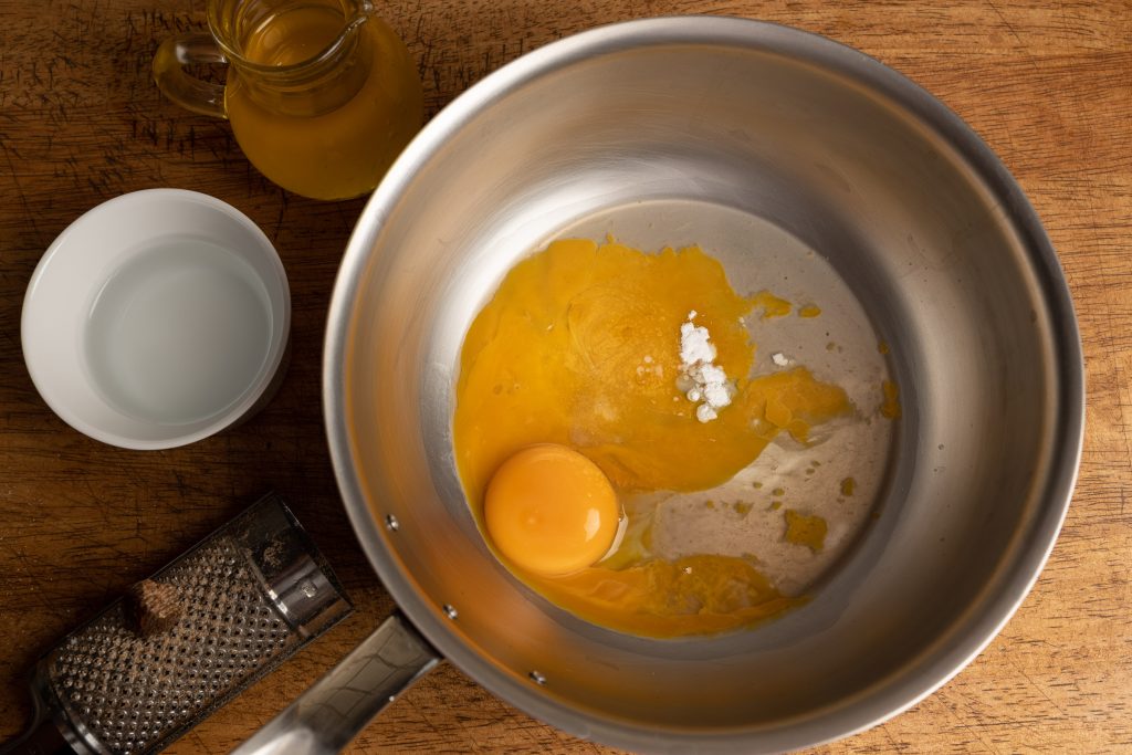 Egg yolks with reduction and starch in a copper pot
