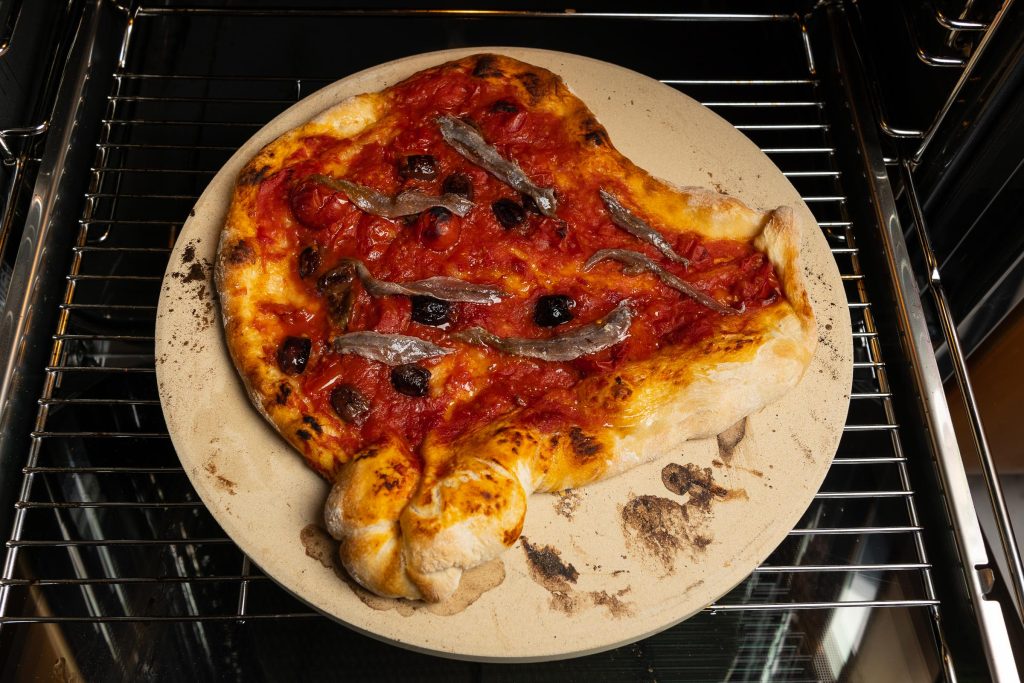 Anchovy pizza in the oven