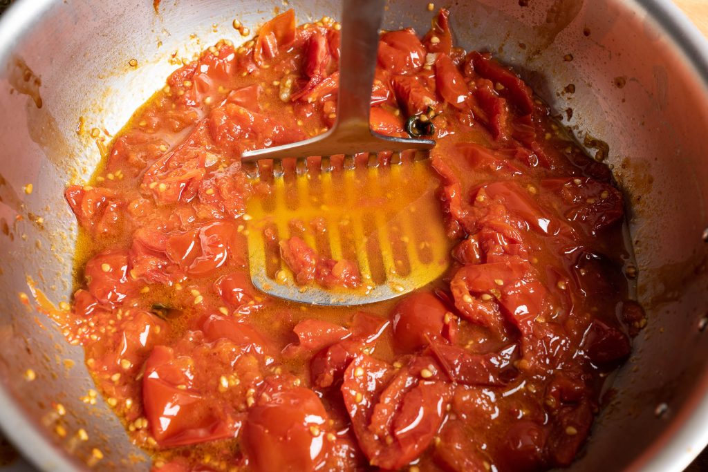 Crushed stewed tomatoes in a saucepan