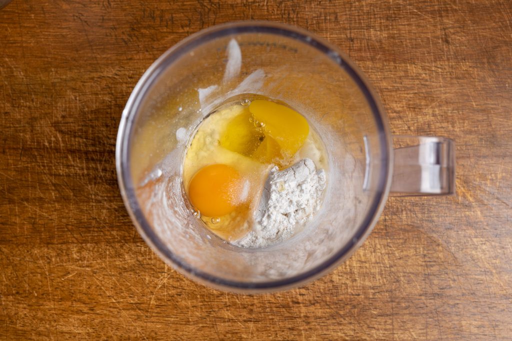 Eggs with salt and sugar in mixer jar for pancake batter