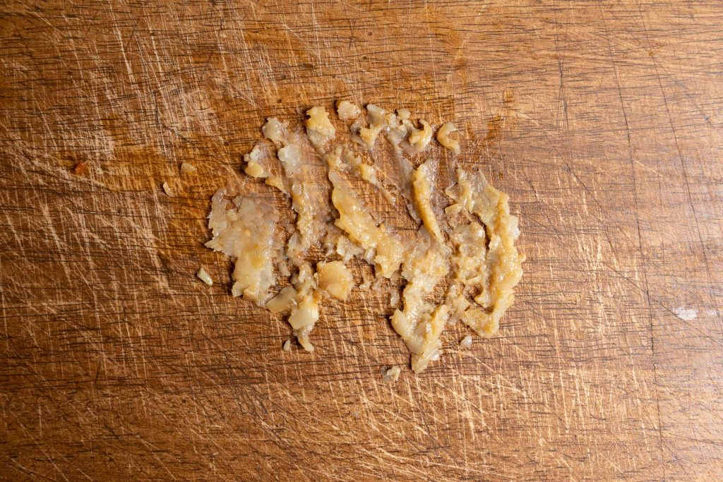 Garlic paste on cutting board