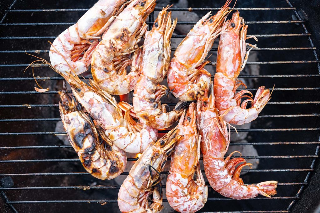 Grilling prawns on a charcoal grill